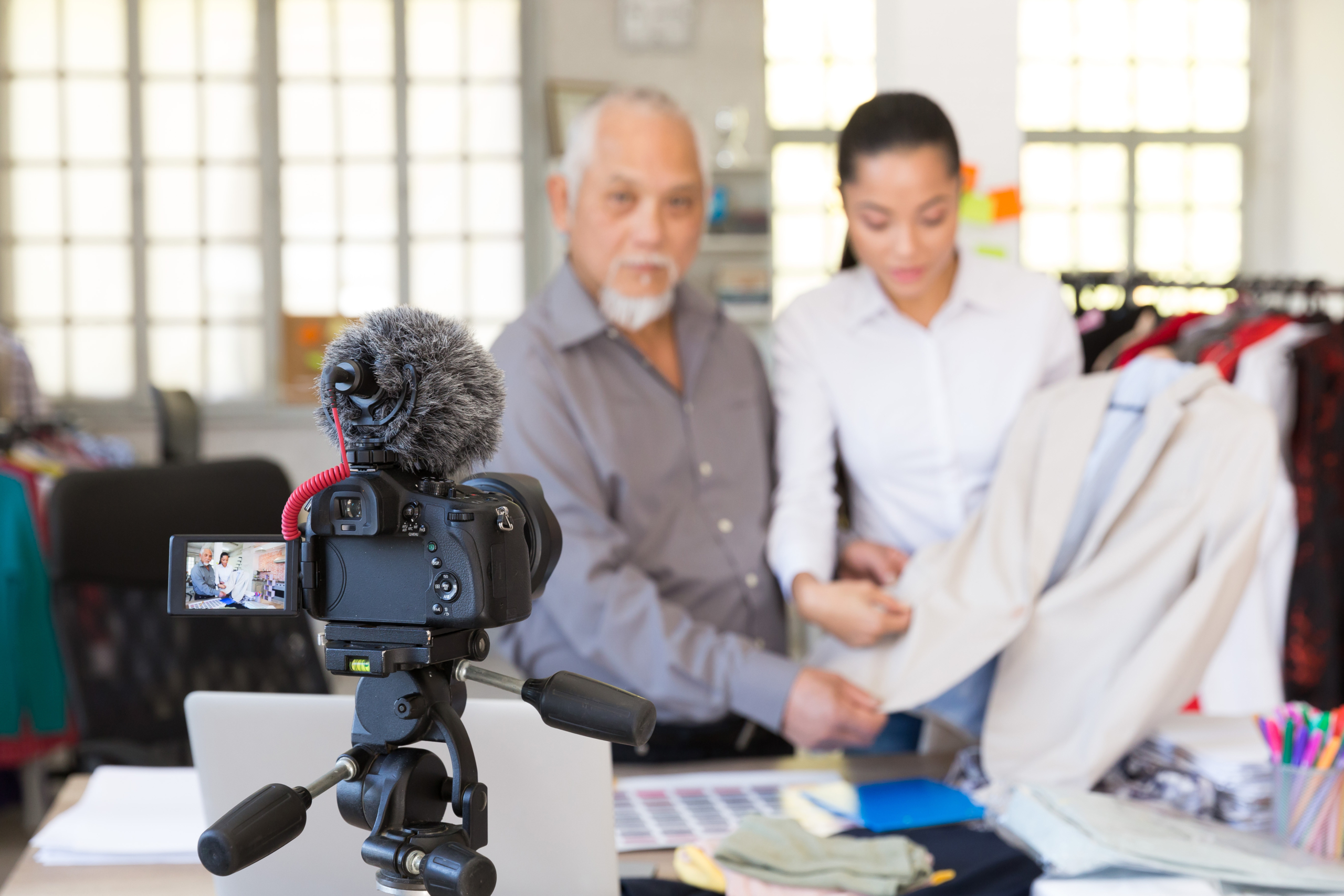 Fashion vloggers making video at textile factory